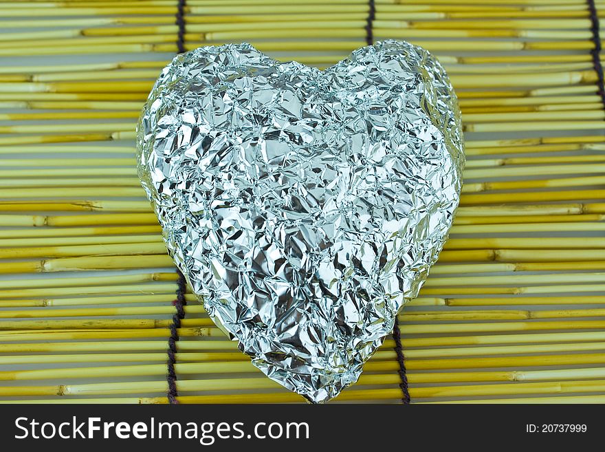 Isolated Silver heart on bamboo blind
