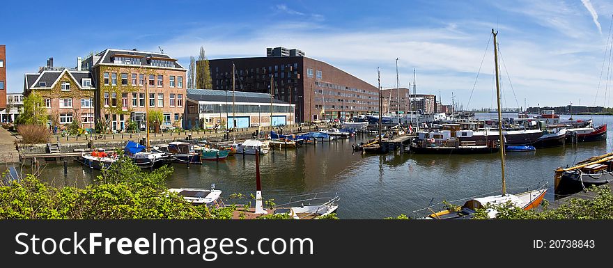 Channels in Amsterdam. Modern residential districts. Marina for boats and yachts.