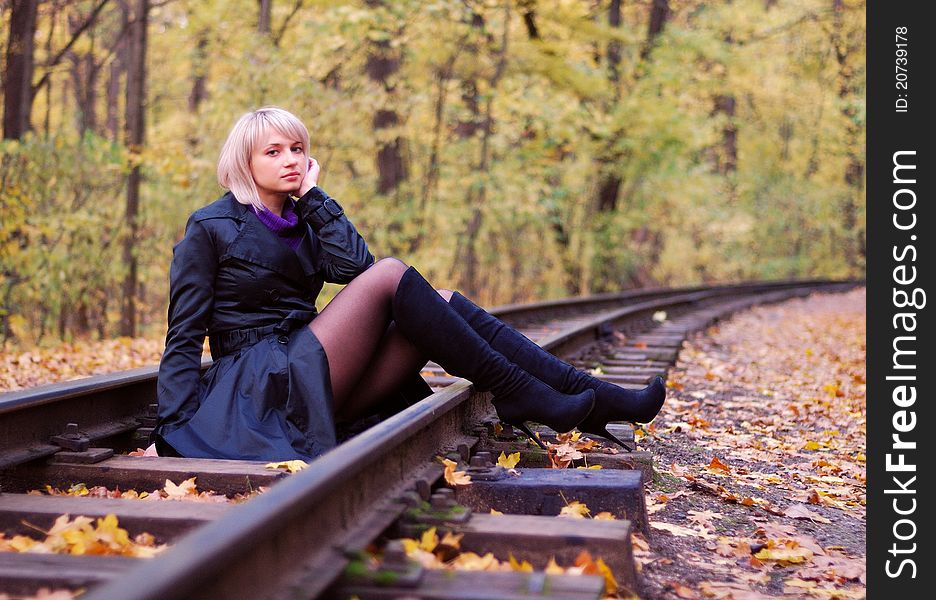 Beautiful Girl Posing On Rails In Autumn Park