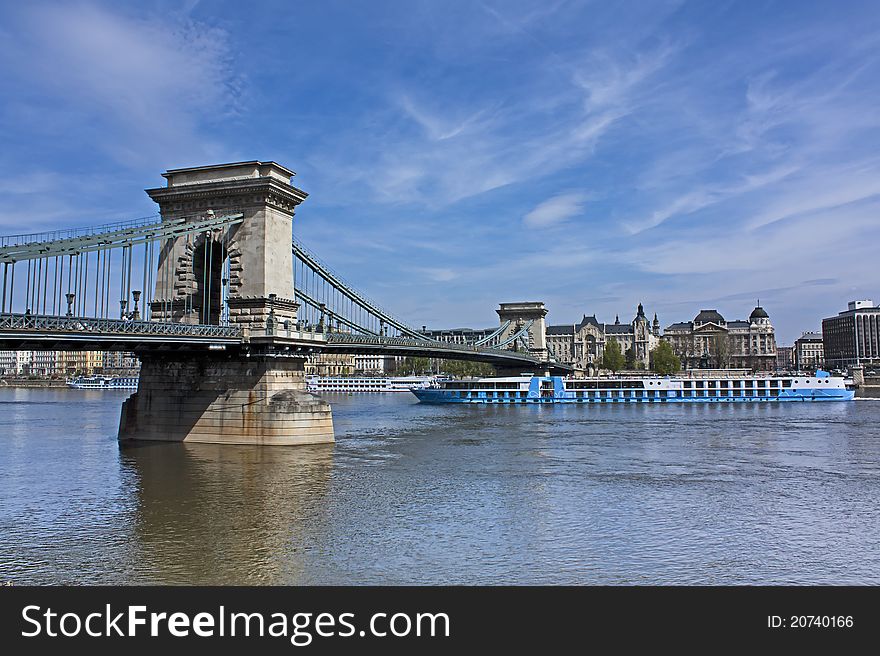 International river boat heading north on the river danube passing under the chain bridge (lanchid). International river boat heading north on the river danube passing under the chain bridge (lanchid)