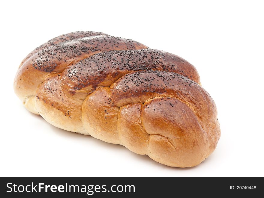 Loaf sprinkled with poppy seeds on a white background