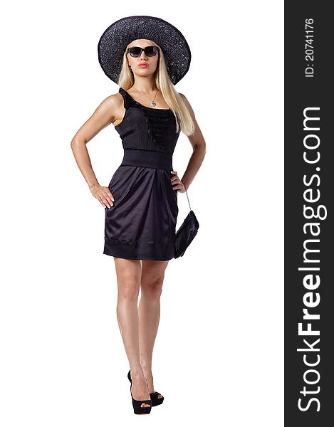 Portrait of a beautiful woman wearing black dress, hat and sunglasses. Isolated over white