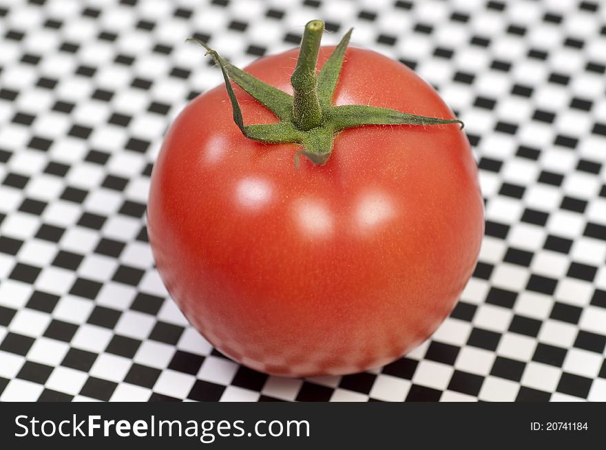 Isolated fresh tomato on pattern background