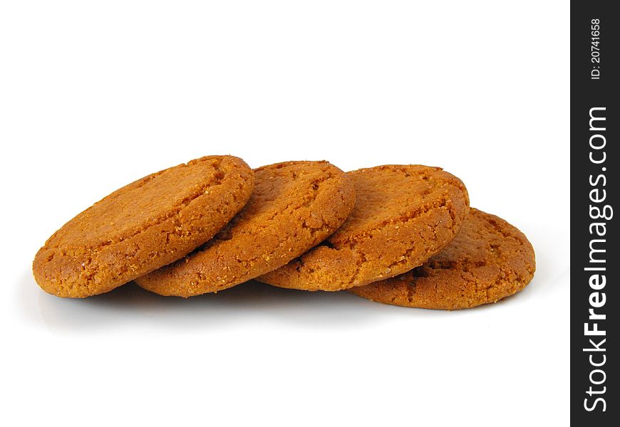 A row of ginger biscuits on a white background.
