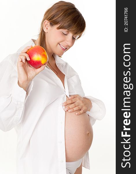 Pregnant woman holding an apple. Pregnant woman holding an apple