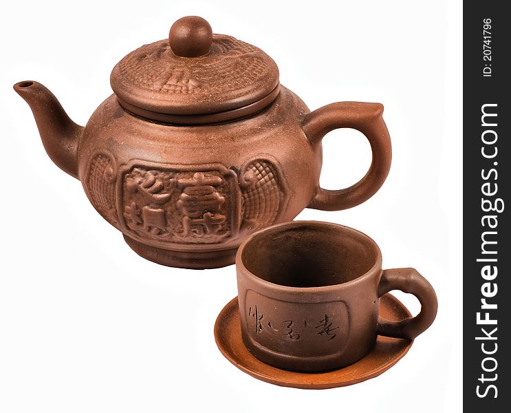 Brown ceramic traditional Chinese tea service is isolated on a white background