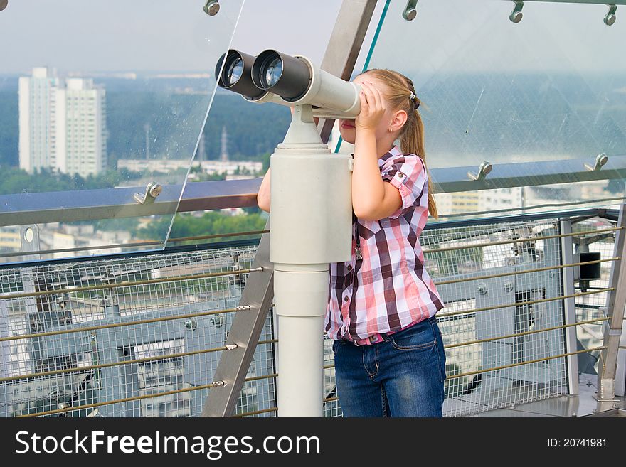 A Girl Looks Through A Telescope