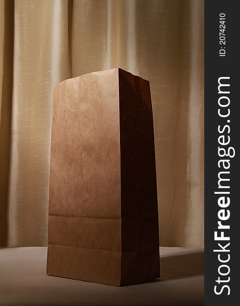 Beautiful paper bag against textured backdrop. Beautiful paper bag against textured backdrop