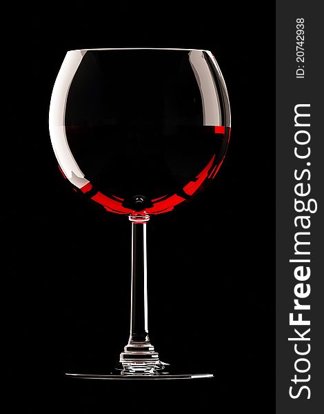 Glass of red wine on black background