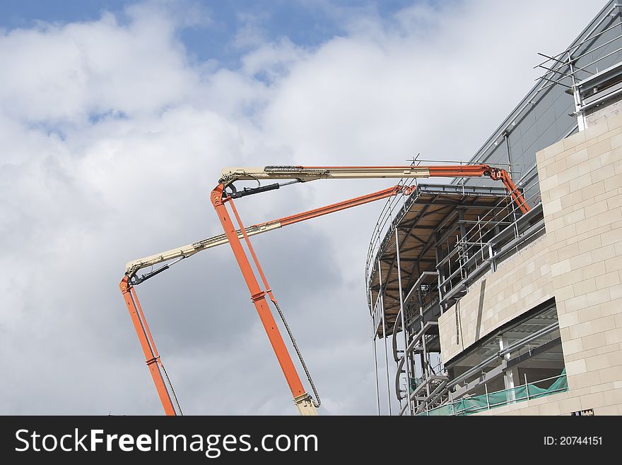 Two High Lift Cherry Picker Platforms on a Construction Site. Two High Lift Cherry Picker Platforms on a Construction Site