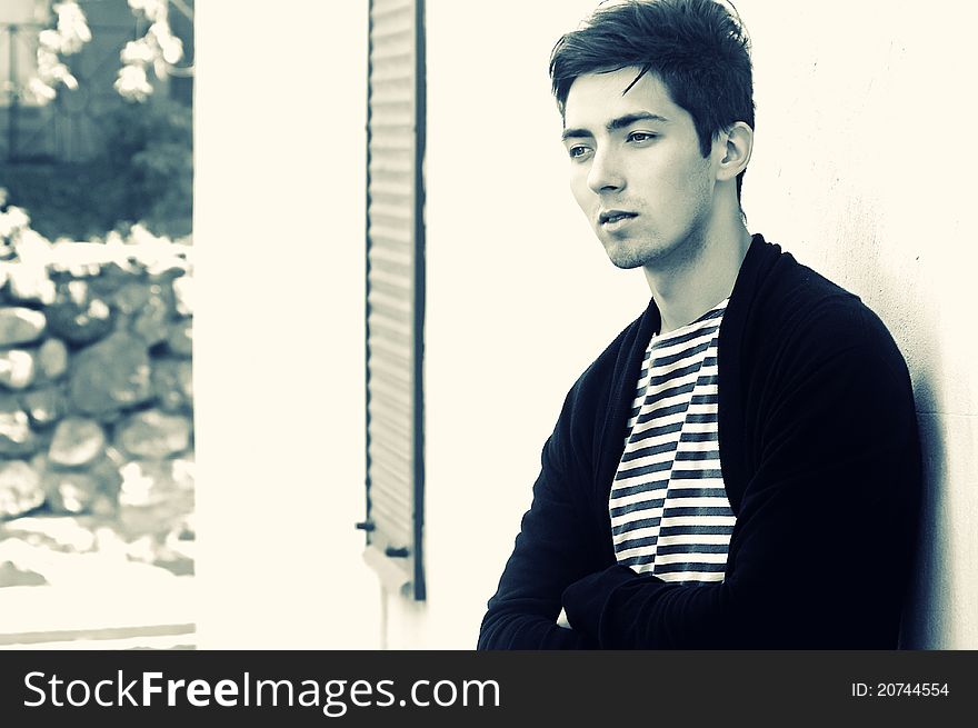 Young thoughtful man staying outside