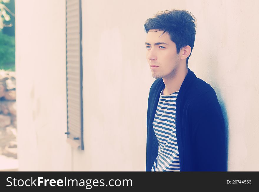 Young thoughtful man staying outside