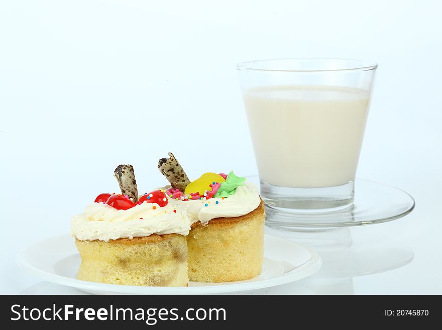 Cup cake and milk on white background