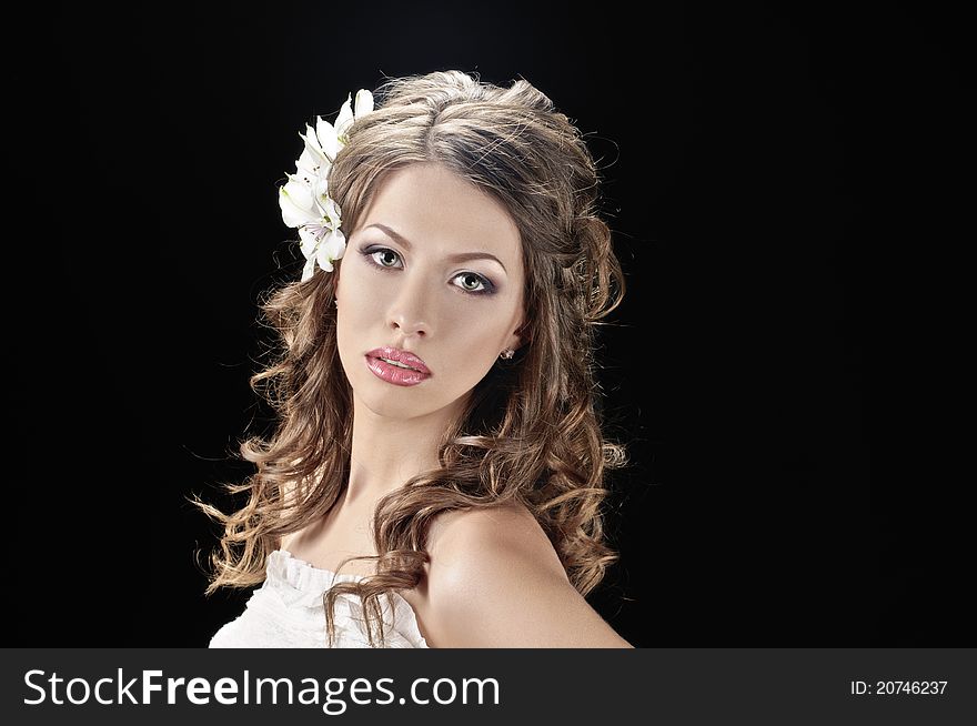 Portrait of beautiful bride with flowers in hair on black. Portrait of beautiful bride with flowers in hair on black