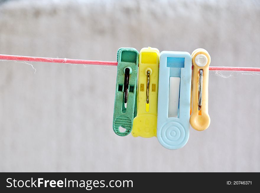 Clothespin hang on a cord on white