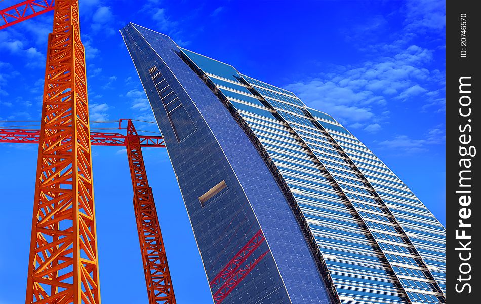 Skyscraper construction crane and a blue background.