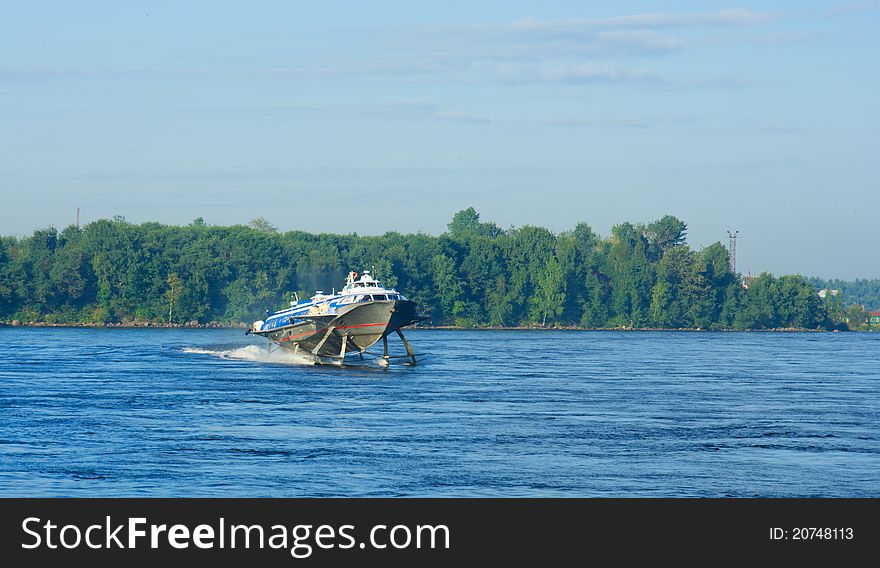 The passenger boat on hydrofoils going down the river on a summer day