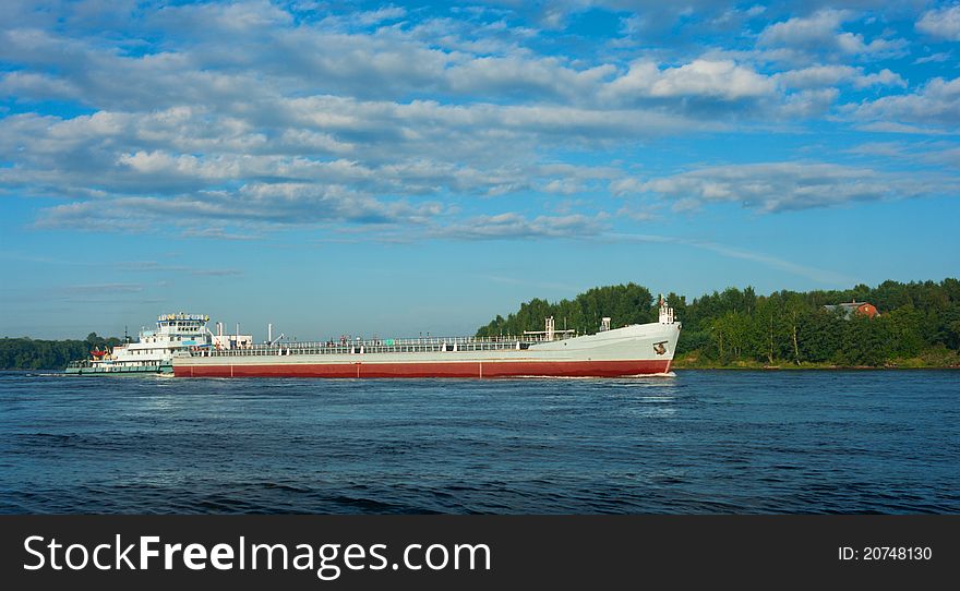 Barge going down the river on a summer day. Barge going down the river on a summer day