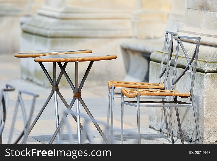 Round tables and wicker chairs in cafe in Paris. Photo with tilt-shift effect. Round tables and wicker chairs in cafe in Paris. Photo with tilt-shift effect