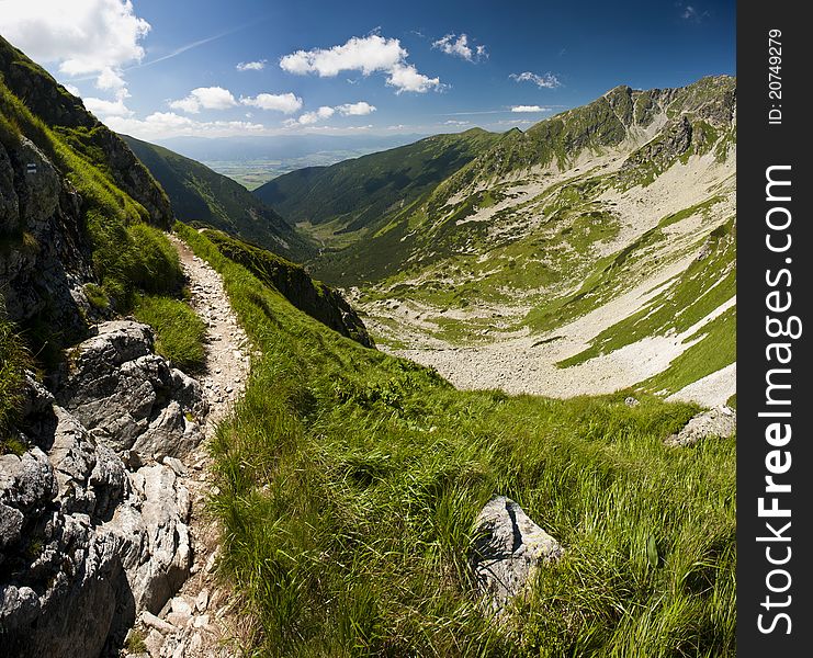 Panorama from mountains in summer day with a path. Panorama from mountains in summer day with a path