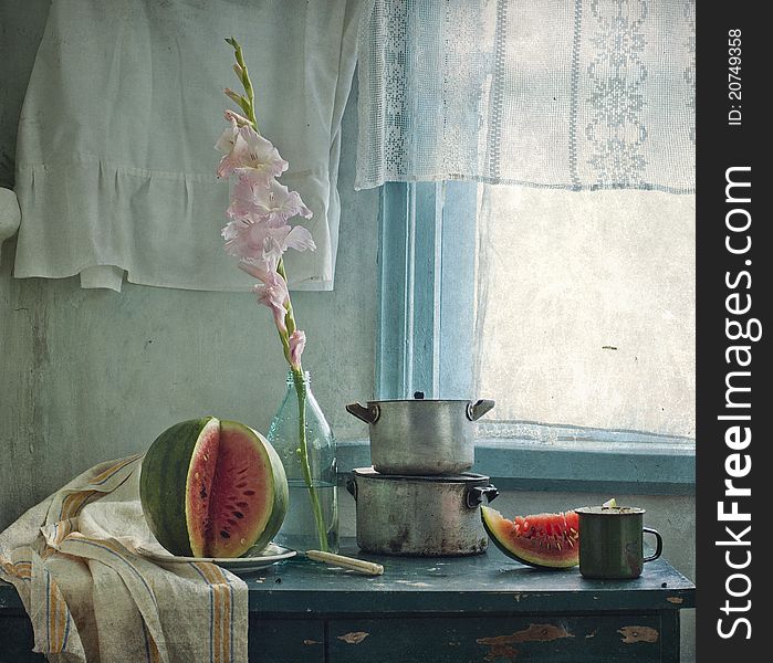 Still life with a gladiolus by a water-melon and pans. Still life with a gladiolus by a water-melon and pans