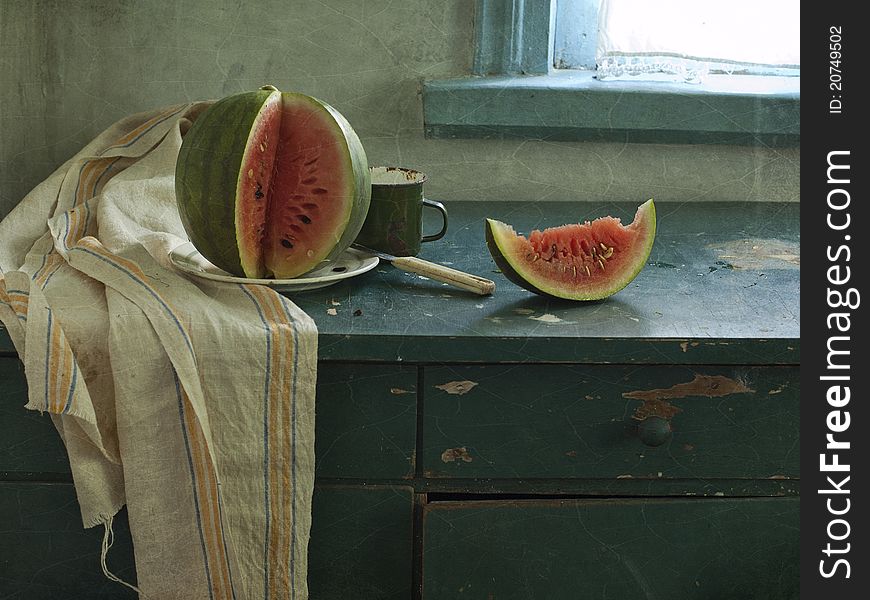 Still life with a red water-melon and green cup