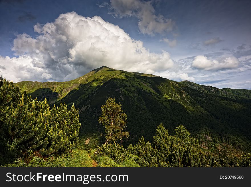 Summer mountains scenery with cloudy sky, filtered tonal range