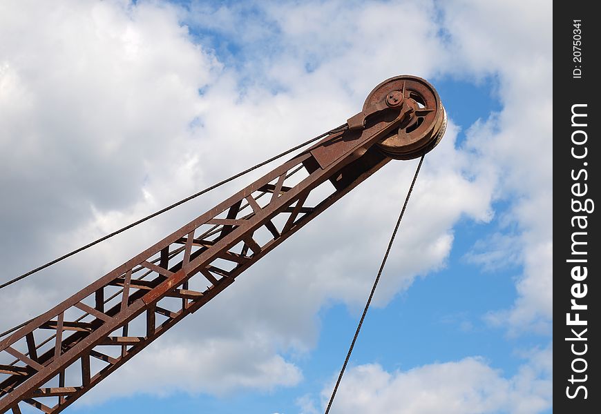 Silhouette of a crane boom against a cloudy sky. Silhouette of a crane boom against a cloudy sky.