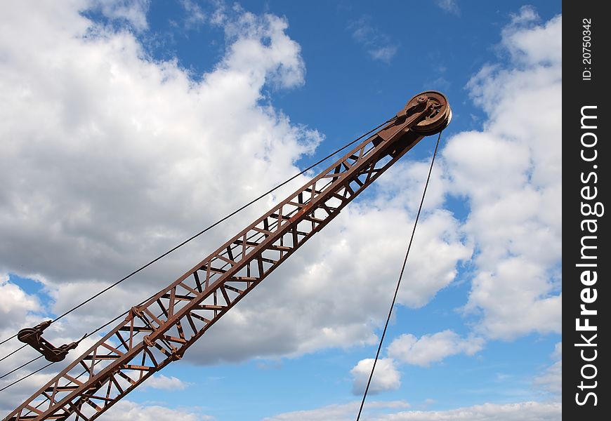 Silhouette of a crane boom against a cloudy sky. Silhouette of a crane boom against a cloudy sky.