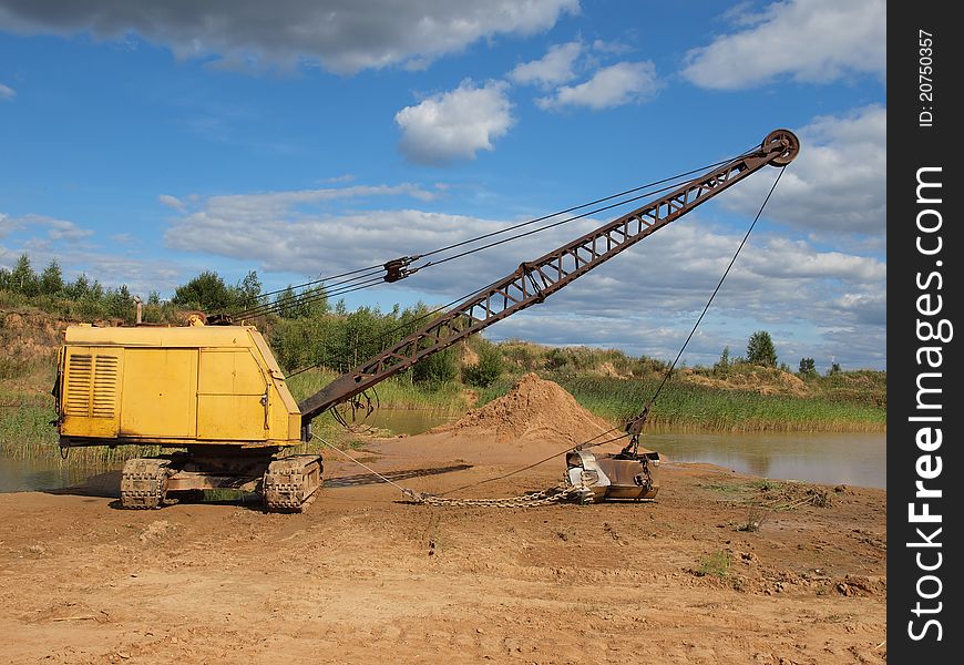 Old yellow excavator in sandy to career. Old yellow excavator in sandy to career.