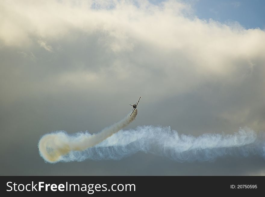 Airplane performing difficult maneuver in the sky. Airplane performing difficult maneuver in the sky.