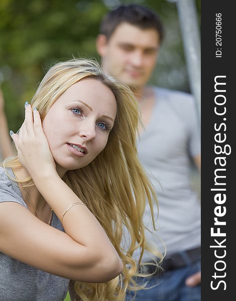 Young couple outdoor - focus on female in foreground