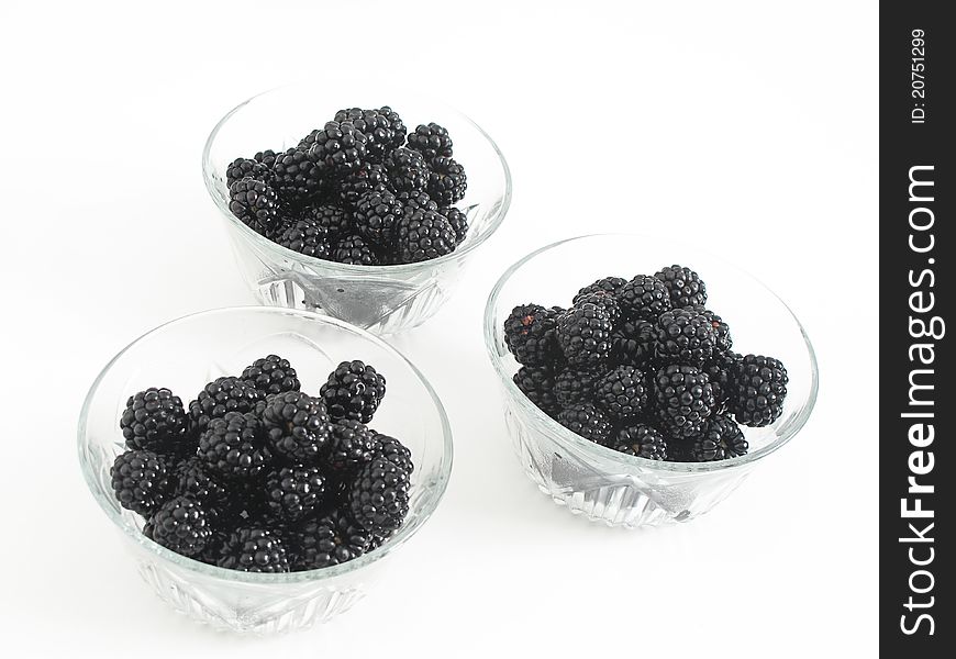 Glass cups with delicious dessert sweet blackberries