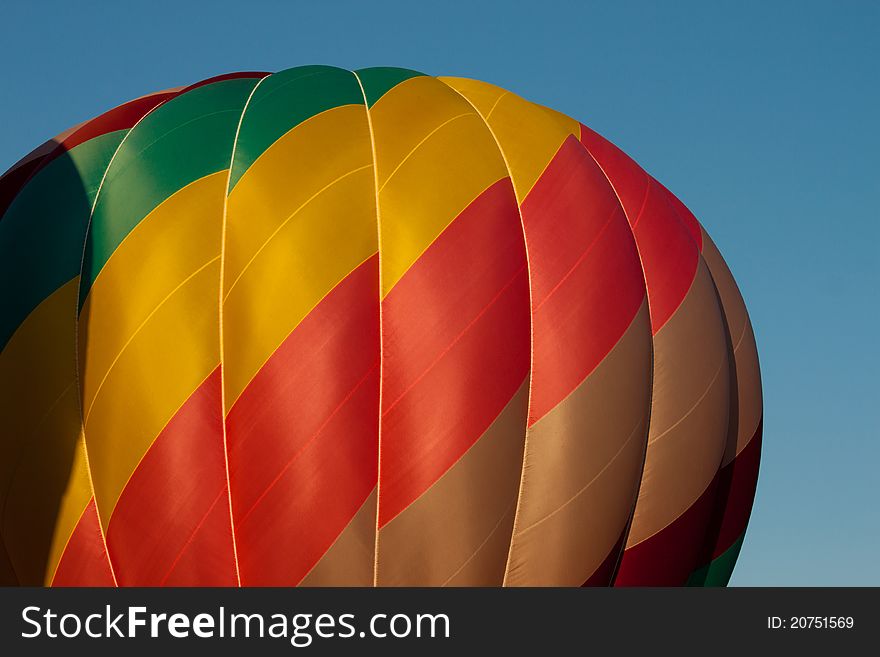 Image of a hot air balloon against blue sky. Image of a hot air balloon against blue sky