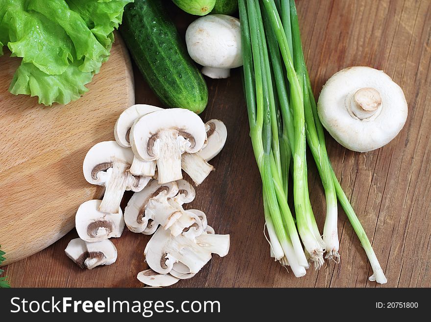 Fresh vegetables on the wooden background at the kitchen. Fresh vegetables on the wooden background at the kitchen