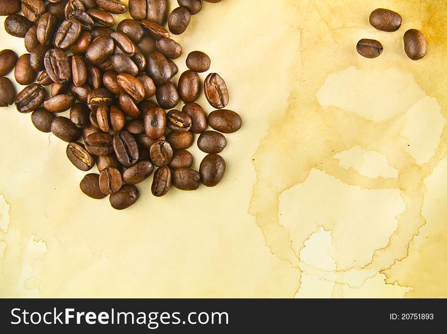 Coffee Beans On A Texture Of Stained Paper