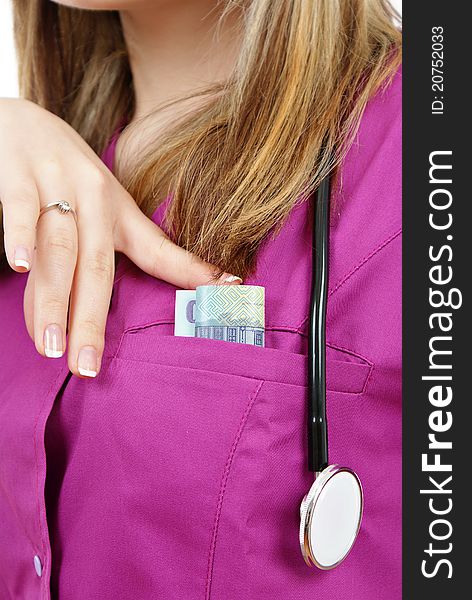 Beautiful nurse with stethoscope and money in her pocket