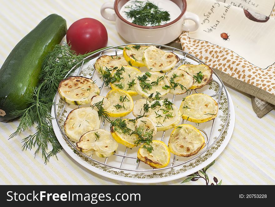 Fried zucchini on the grill with dill and sour cream. Fried zucchini on the grill with dill and sour cream