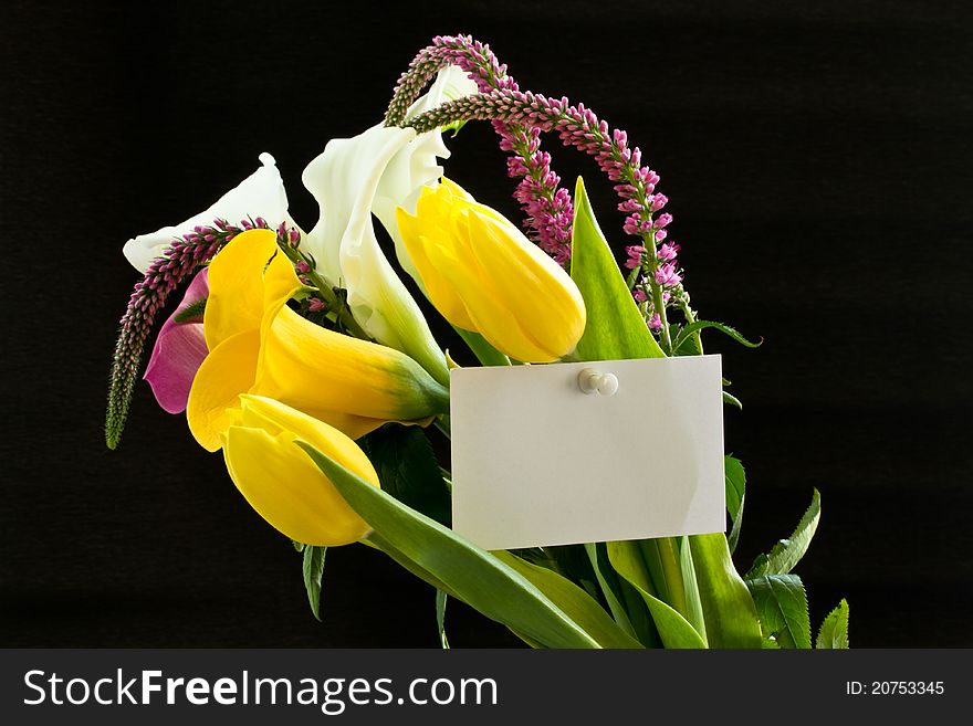 Beautiful bouquet of tulips and calla lilies on a black background