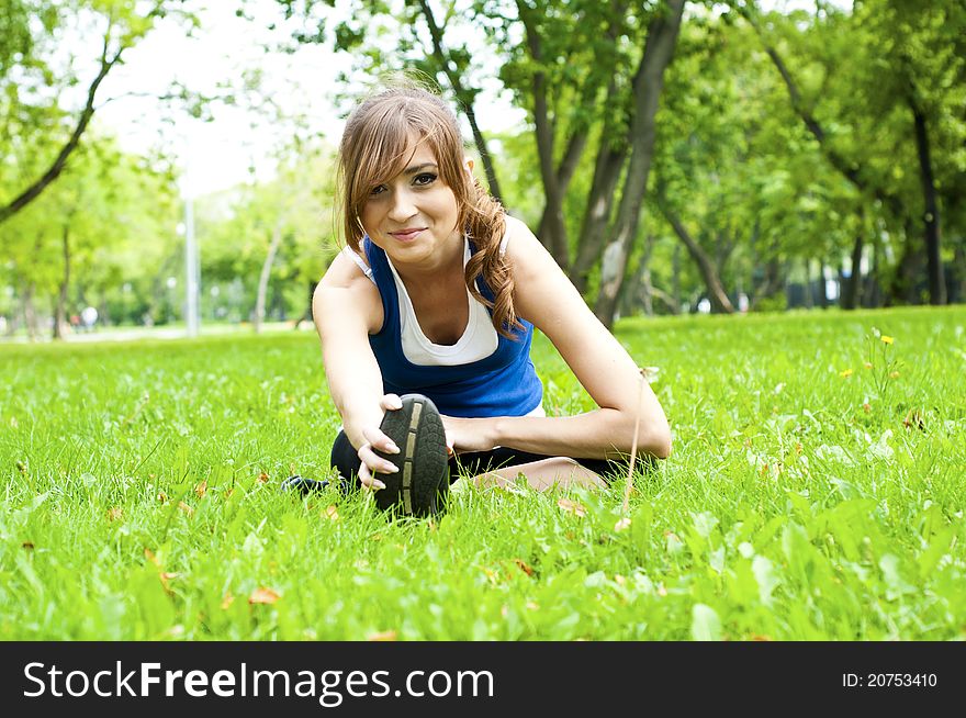 Young woman is engaged in yoga, in summer forest on a green grass. Young woman is engaged in yoga, in summer forest on a green grass