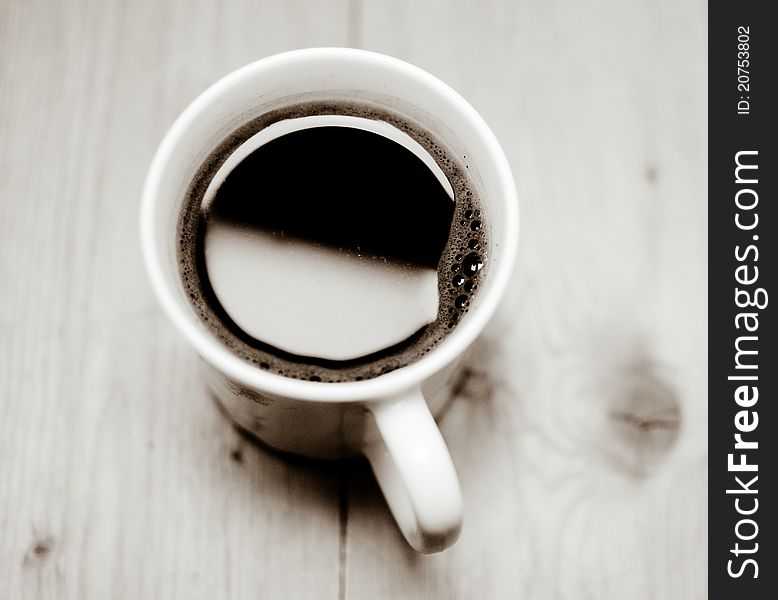 A cup of coffee is on the table. Good morning!. A cup of coffee is on the table. Good morning!