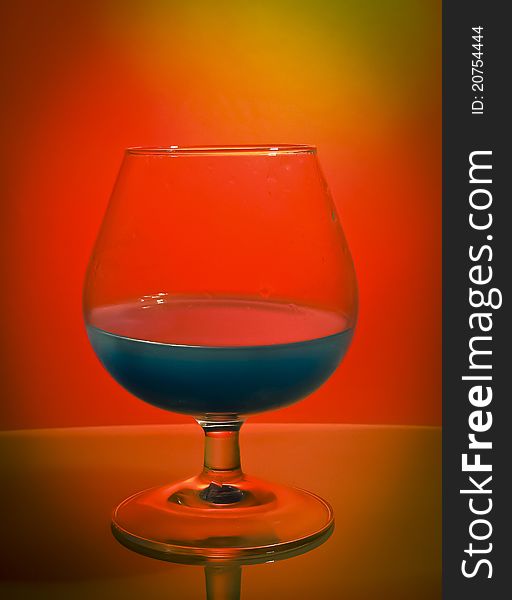 A glass with blue liquid. A glass with blue liquid.
