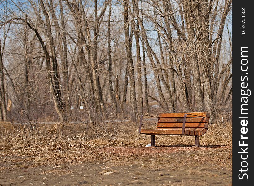 Park bench in bow valley park pathway Calgary Alberta. Park bench in bow valley park pathway Calgary Alberta