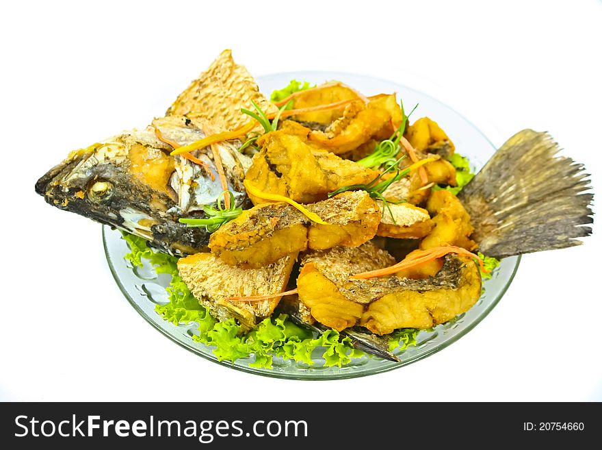 Fried fish on dish with white background