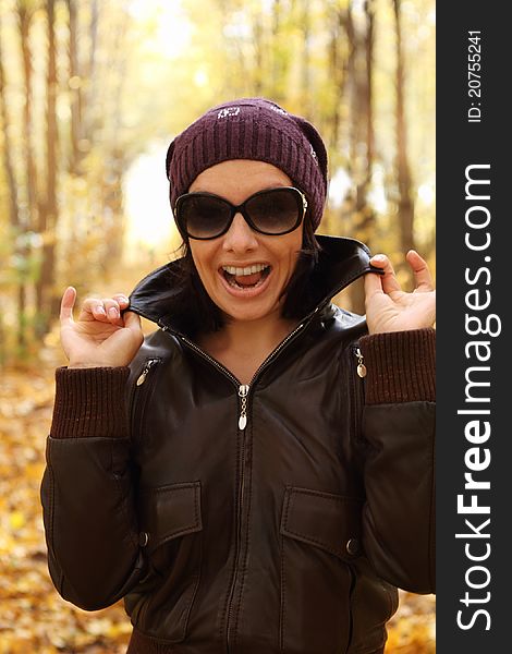 Young attractive woman in sun glasses in autumn park. Young attractive woman in sun glasses in autumn park