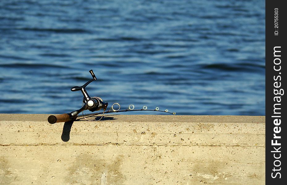 A fishing rod on a concrete