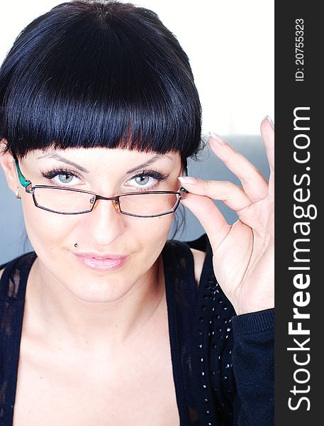 Closeup of beautiful brunette woman holding glasses