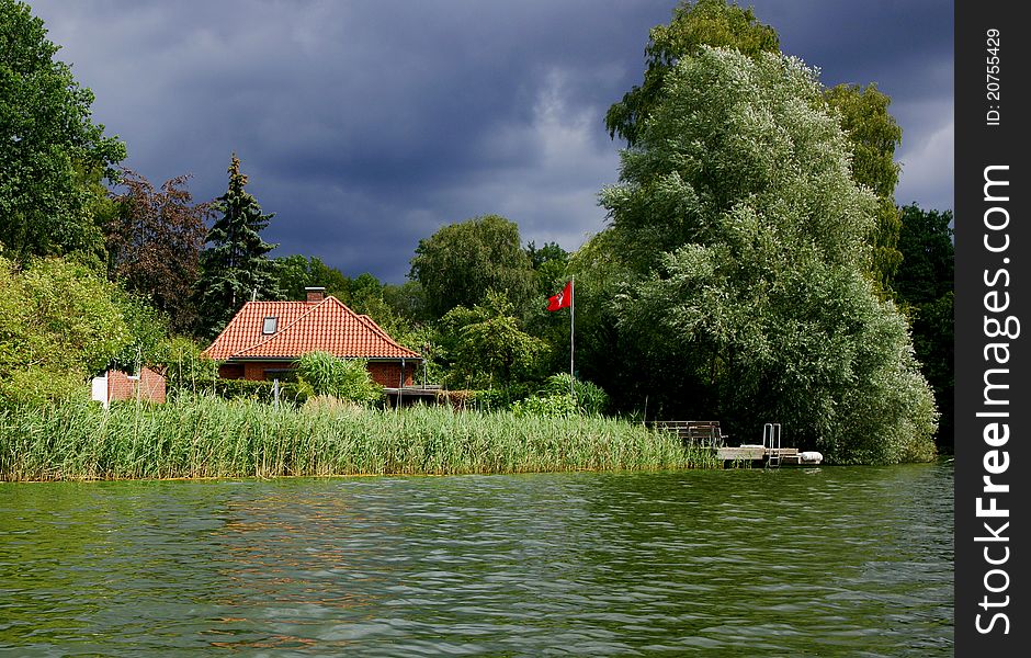 A storm is moving in on a house on the shore of Lake Ziegelsee near Moelln in Northern Germany. A storm is moving in on a house on the shore of Lake Ziegelsee near Moelln in Northern Germany.