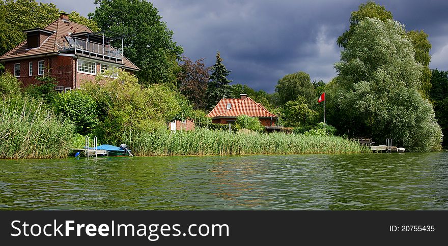 A storm is moving in on some houses on Lake Ziegelsee near the town of Moelln, Schleswig-Holstein (Germany). A storm is moving in on some houses on Lake Ziegelsee near the town of Moelln, Schleswig-Holstein (Germany).