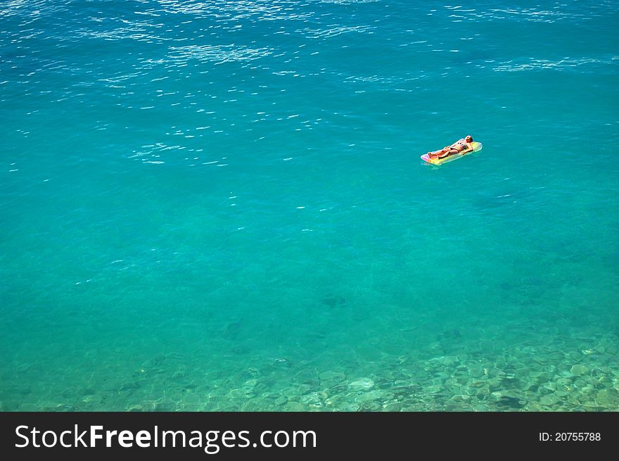 Girl sunbathing on adriatic waters